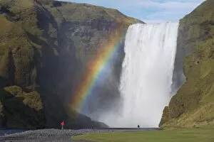Images Dated 1st October 2008: Tourist in red jacket at 62 m high Skogafoss waterfall, Skogar, South area