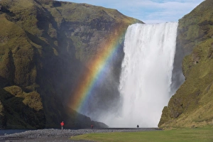 Images Dated 1st October 2008: Tourist in red jacket at 62 m high Skogafoss waterfall, Skogar, South area