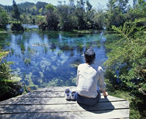 Golden Bay Prints: A tourist sitting on the edge of Pupu springs