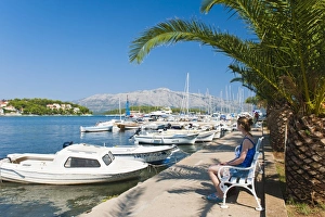 Korcula Prints: Tourist sitting in Lumbarda Harbor
