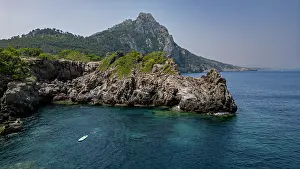 Paddling Prints: Tourist on a stand up paddleboard exploring turquoise waters near Alcudia in Mallorca