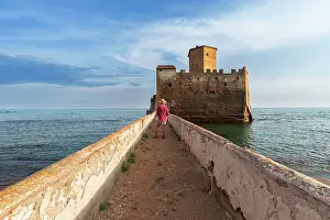 Ancient Rome Prints: Tourist standing on top of the boardwalk admiring Torre Astura Castle