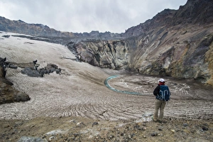 Tourist standing on a glacierfield on Mutnovsky volcano, Kamchatka, Russia, Eurasia