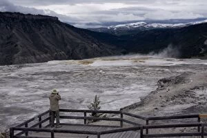 Images Dated 26th May 2008: Tourist viewing geysers, Yellowstone National Park, UNESCO World Heritage Site