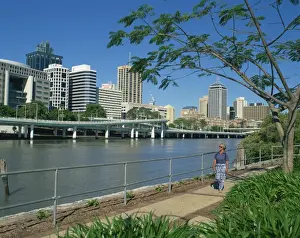 Brisbane Prints: Tourist walking beside the Brisbane River and the city skyline behind, Brisbane