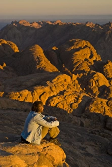 Tourist watching the sunrise on top of Mount Sinai, Egypt, North Africa, Africa