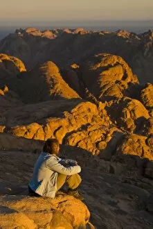 Tourist watching the sunrise on top of Mount Sinai, Egypt, North Africa, Africa
