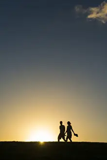 Heterosexual Couple Prints: Tourists in backlight walking to the Castle of San Felipe del Morro