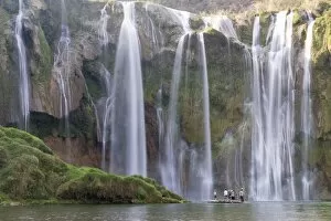 Tourists on a bamboo raft under Jiulong Falls (Nine Dragon waterfall), Luoping