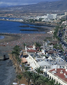 Tourists on the beach at Playa Troya, Puerto Colon, at the Playa de Las Americas