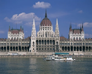 Danube Prints: Tourists on a boat on the River Danube pass the Parliament