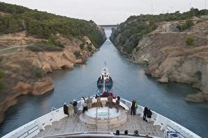 Cruising Prints: Tourists on the bow of a small cruise ship being pulled by a tug