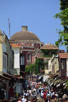 Rhodes Town Prints: Tourists in busy back street with church dome behind