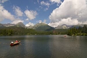 Tourists in a canoe at the Glacier lake of Strebske Pleso in the High Tatra