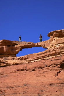 Rock Cliffs Prints: Tourists climbing at Wadi Rum, Jordan, Middle East