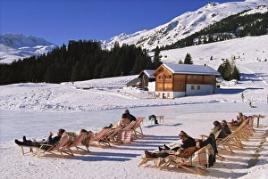 Deck Chair Prints: Tourists in deck chairs on the snow in winter