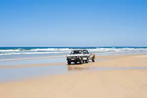 Fraser Island Prints: Tourists driving on Seventy Five Mile Beach on a self drive 4x4 tour of Fraser Island