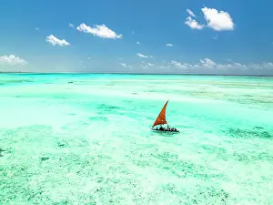 Sailboat Prints: Tourists enjoying a boat trip on traditional dhow in the crystal sea