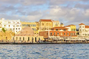 Tourists enjoying sunset at the old Venetian port of Chania, Crete, Greek Islands, Greece