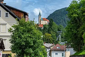 Attractions Prints: Tourists explore the historic mercury mine of Idrija while admiring surrounding landscapes in Slovenia on a clear day