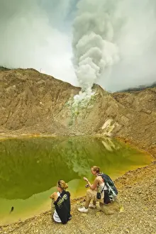 Steaming Prints: Tourists by green crater lake and fumaroles at Papandayan Volcano