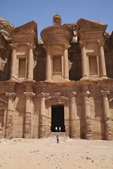 Classical Style Prints: Tourists being photographed at the facade of the Monastery carved into the red rock at Petra