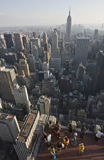 Tourists photographing view of the Empire State Building from the top of the General Electric Building, (Top of the Rock), Rockefeller Centre, Manhattan, New York, United States of America