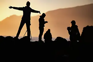 Silhouettes Prints: Tourists take photos on the beach at sunset in Madeira
