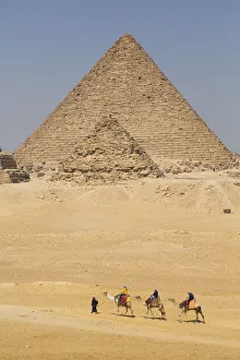 Tourists riding camels, Great Pyramids of Giza, UNESCO World Heritage Site, Giza, Egypt