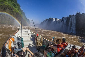 Tourists take a river boat to the base of the falls, Iguazu Falls National Park