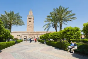 Koutoubia Prints: Tourists sitting in the gardens next to the Koutoubia Mosque