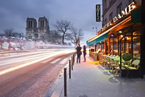 Photographing Prints: Tourists stop to photograph Notre Dame de Paris cathedral at dawn, Paris, France, Europe