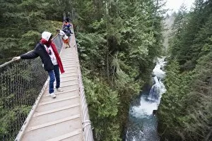 Tourists on a suspension bridge in Lynn Canyon Park, Vancouver, British Columbia, Canada