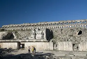 Restored Prints: Tourists in front of the unusual restored Atlantes stone carved male figures at rear of the Palace of Masks
