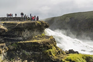 Tourists visiting Gullfoss (Golden Falls), a waterfall located in the canyon of