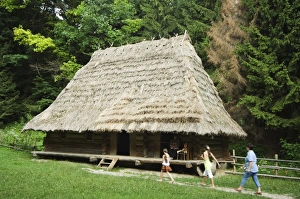 Straw Prints: Tourists visiting traditional thatched roof house in