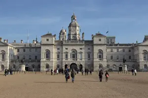 Whitehall Prints: Tourists walk towards the arch of Horse Guards Parade under a winters blue sky
