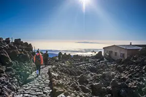Adults Prints: Tourists walking down from top of El Teide volcano to Teide Cable Car in early moning