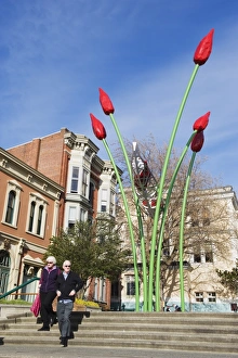 Images Dated 21st April 2009: Tourists walking under a flower installation in Bastion Square, Victoria