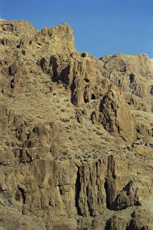 Arid Landscapes Prints: Tourists walking through rocky landscape in Wadi Rumdan, south of Judea