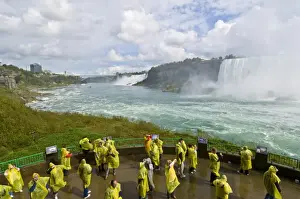 Weekend Activities Prints: Many tourists in yellow raincoats in the spray of the Horseshoe Falls waterfall whilst on the Journey under the Falls