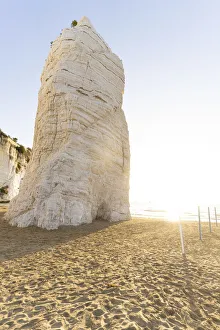 Apulia Prints: Towering white rock monolith Pizzomunno at sunrise, Vieste, Foggia province