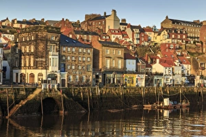 Townhouses, bars and restaurants on Pier Road, West Side of River Esk, lit by low sun in winter