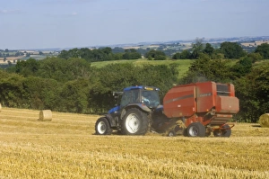 Gathering Prints: Tractor collecting hay bales at harvest time, seen from the Cotswolds Way footpath