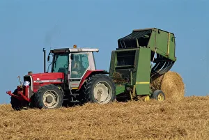 Harvest Prints: Tractor towing baler unloading drum bale, Wannock, Sussex, England, United Kingdom