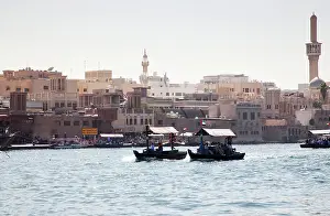 Passenger Prints: Traditional Abra ferries crossing Dubai Creek which divides the city into two sections of Deira and Bur Dubai