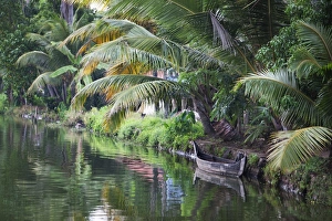 Absence Prints: Traditional boat moored on the still water of the Kerala Backwaters, Kerala, India, Asia
