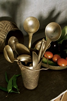 Brassware Prints: Traditional brass kitchen utensils in a home