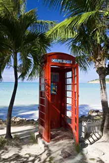 Telephone Box Prints: Traditional English red telephone box on the beach at Dickenson Bay, Antigua
