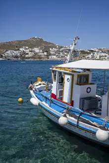 Mykonos Prints: Traditional fishing boat moored in the harbour at Ornos Beach